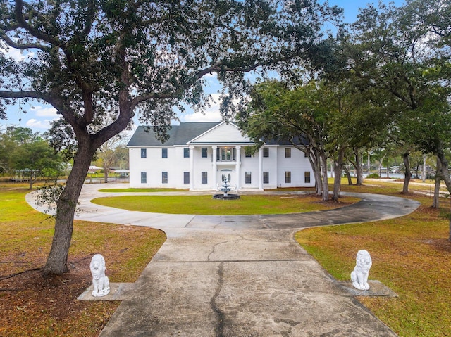 680 Mallet Bayou Rd, Freeport, FL 32439 - greek revival inspired property featuring a front yard and curved driveway