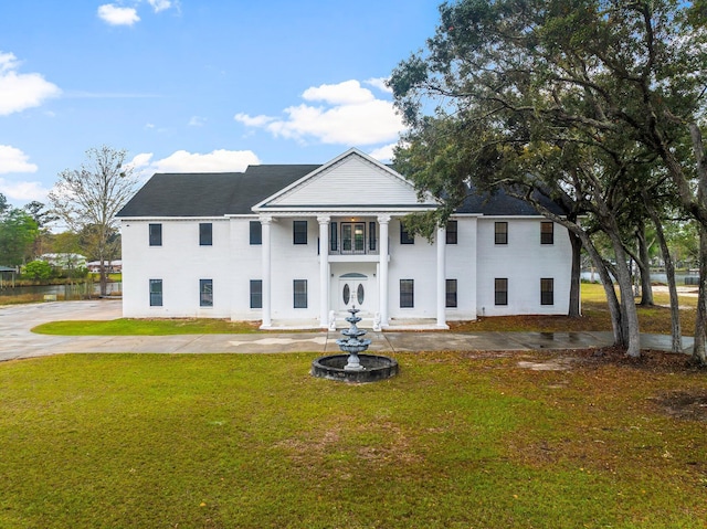 680 Mallet Bayou Rd, Freeport, FL 32439 - greek revival house with a balcony and a front yard