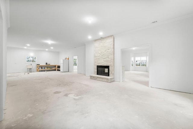680 Mallet Bayou Rd, Freeport, FL 32439 - unfurnished living room featuring visible vents, ornamental molding, recessed lighting, a stone fireplace, and unfinished concrete flooring