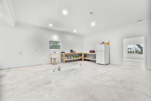 680 Mallet Bayou Rd, Freeport, FL 32439 - garage with visible vents, recessed lighting, and freestanding refrigerator