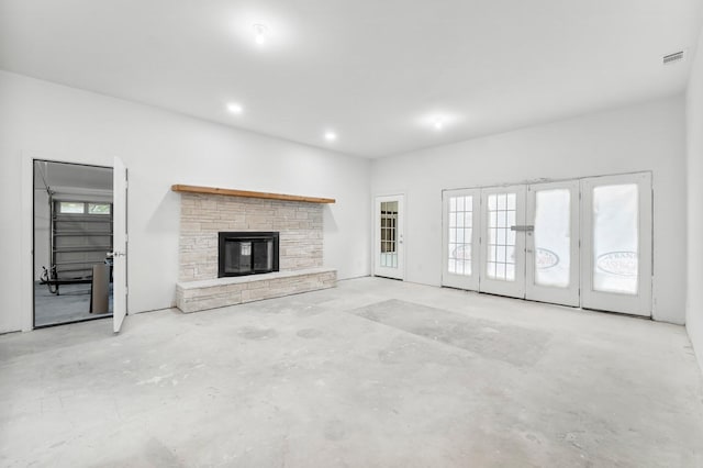680 Mallet Bayou Rd, Freeport, FL 32439 - unfurnished living room featuring concrete flooring, recessed lighting, french doors, visible vents, and a fireplace