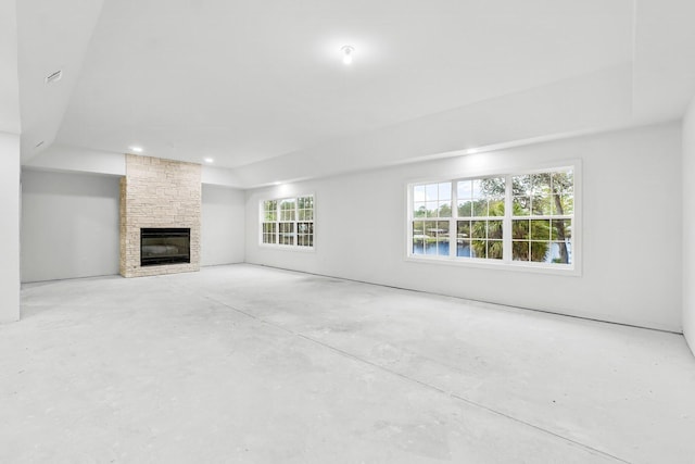 680 Mallet Bayou Rd, Freeport, FL 32439 - unfurnished living room featuring unfinished concrete floors and a stone fireplace