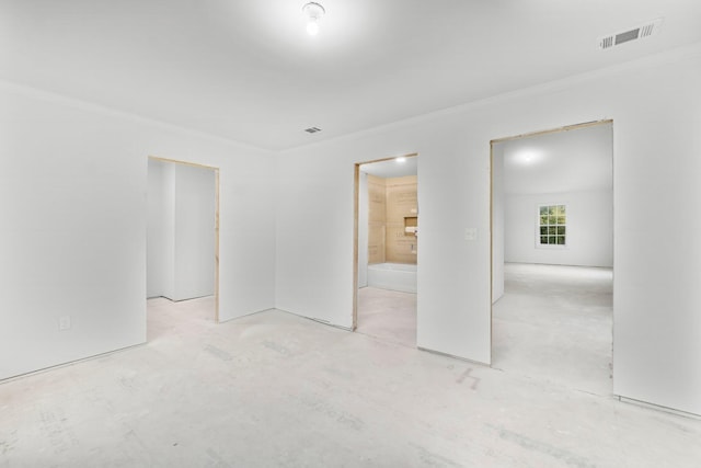 680 Mallet Bayou Rd, Freeport, FL 32439 - unfurnished bedroom featuring connected bathroom, visible vents, and crown molding