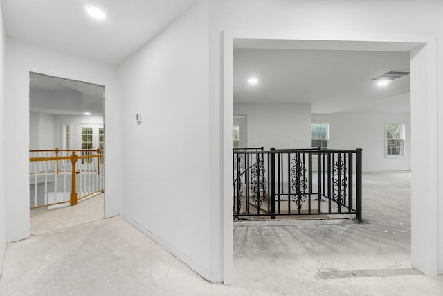 680 Mallet Bayou Rd, Freeport, FL 32439 - hallway featuring visible vents, an upstairs landing, and unfinished concrete floors