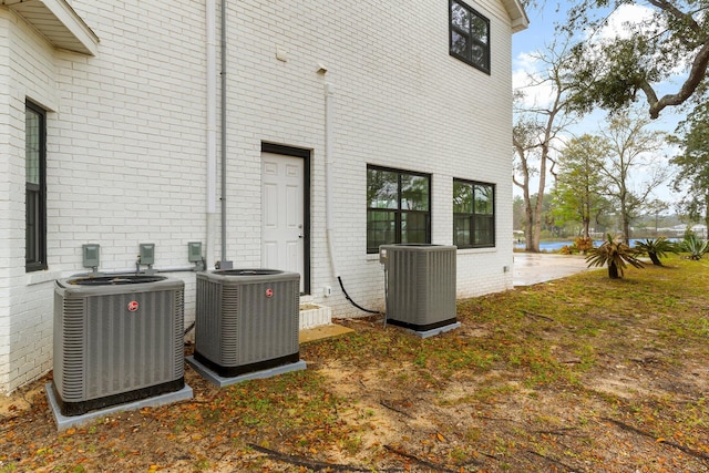 680 Mallet Bayou Rd, Freeport, FL 32439 - rear view of house with central AC unit and brick siding