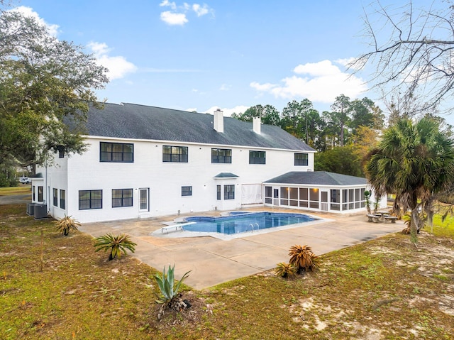 680 Mallet Bayou Rd, Freeport, FL 32439 - rear view of property featuring a sunroom, central AC unit, an outdoor pool, a patio, and a chimney