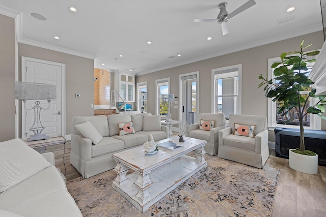 living area featuring baseboards, ornamental molding, wood finished floors, ceiling fan, and recessed lighting