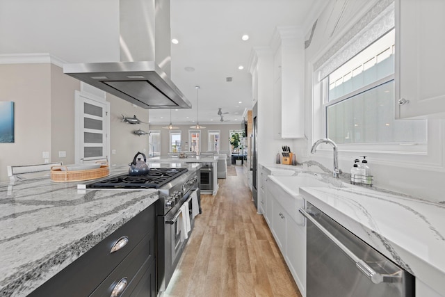 kitchen featuring high end appliances, white cabinets, ornamental molding, and island exhaust hood