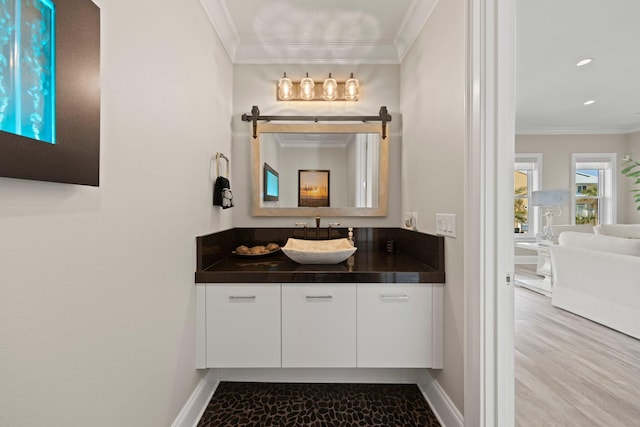 bathroom with baseboards, ornamental molding, recessed lighting, and vanity
