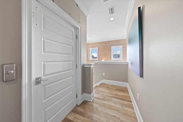 corridor featuring recessed lighting, ornamental molding, baseboards, visible vents, and light wood-style flooring