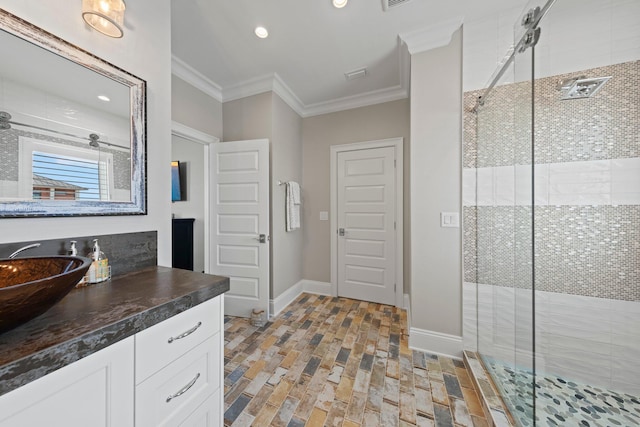 bathroom with baseboards, ornamental molding, vanity, brick floor, and a stall shower