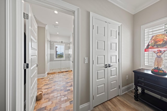 hallway featuring crown molding, brick floor, baseboards, visible vents, and recessed lighting