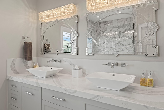 bathroom with double vanity, a sink, and walk in shower
