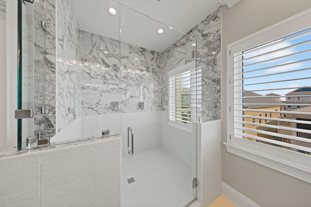 bathroom featuring a marble finish shower and recessed lighting