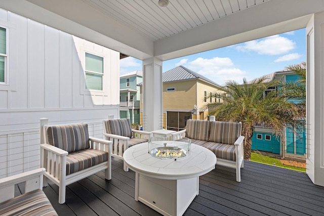 wooden terrace featuring a fire pit