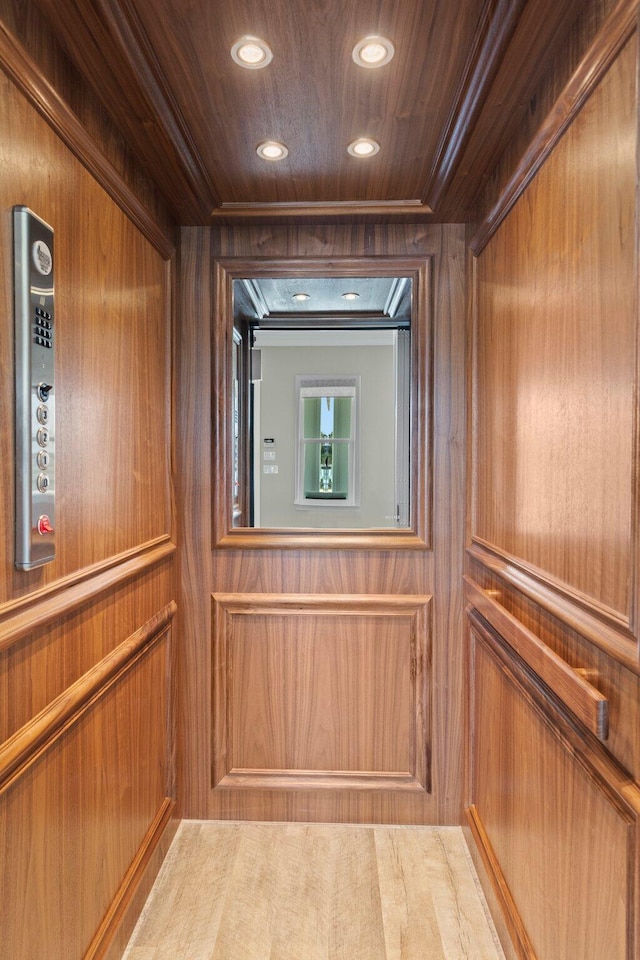 interior details with elevator, wooden ceiling, and recessed lighting