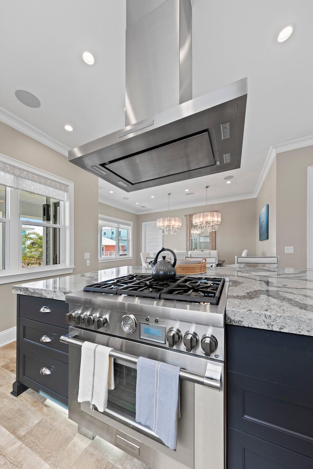 kitchen featuring an inviting chandelier, ornamental molding, high end stainless steel range oven, extractor fan, and light stone countertops