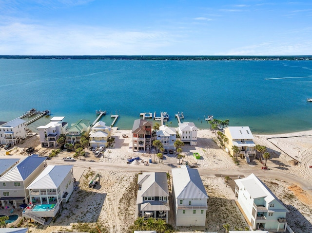 aerial view with a residential view, a water view, and a beach view