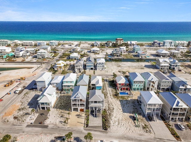 aerial view featuring a view of the beach, a residential view, and a water view