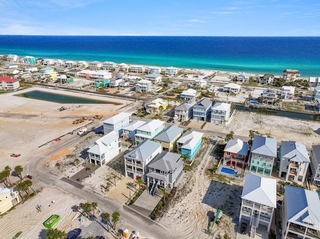 bird's eye view with a water view and a beach view