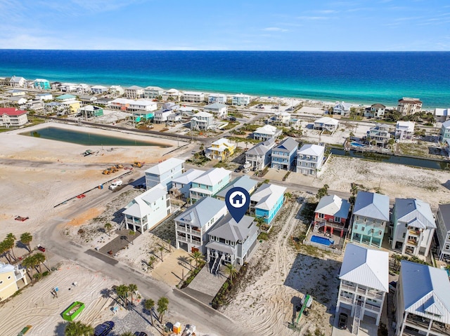 aerial view with a water view and a view of the beach