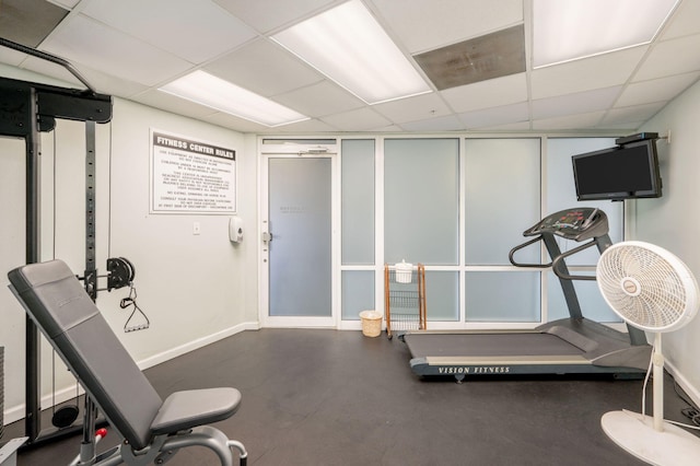 workout area with baseboards and a drop ceiling