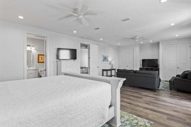 bedroom with visible vents, two closets, ceiling fan, recessed lighting, and wood finished floors