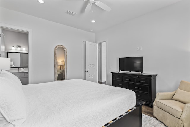 bedroom with light wood-type flooring, recessed lighting, connected bathroom, visible vents, and ceiling fan
