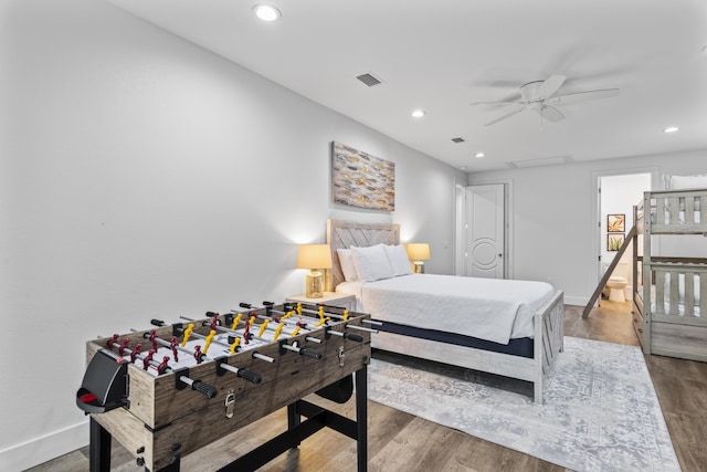 bedroom with wood finished floors, baseboards, visible vents, and recessed lighting