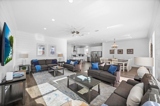 living area featuring recessed lighting, wood finished floors, and ceiling fan with notable chandelier