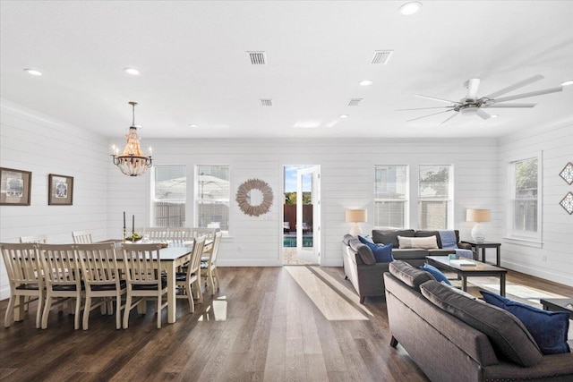 dining room with visible vents, a wealth of natural light, wood finished floors, and ceiling fan with notable chandelier