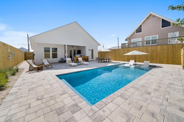 view of swimming pool featuring a fenced backyard, a fenced in pool, ceiling fan, and a patio