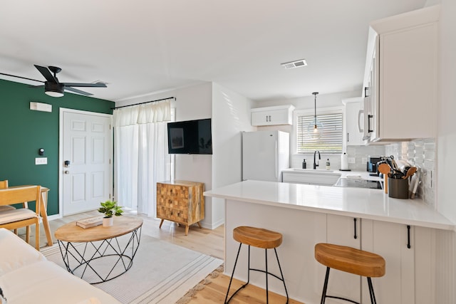 11 Beachside Dr Unit 913, Santa Rosa Beach, FL 32459 - kitchen with light countertops, a peninsula, ceiling fan, white appliances, and decorative backsplash