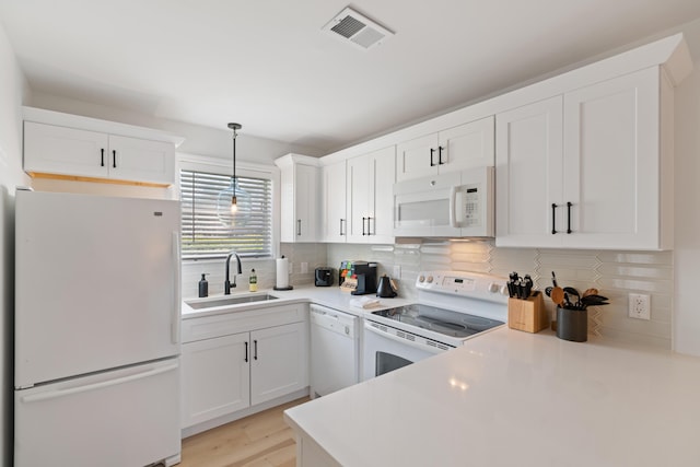 11 Beachside Dr Unit 913, Santa Rosa Beach, FL 32459 - kitchen featuring visible vents, white cabinetry, a sink, and white appliances