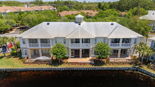 2221 Crystal Cove Ln Unit 2221, Miramar Beach, FL 32550 - back of property with a water view, a balcony, and metal roof