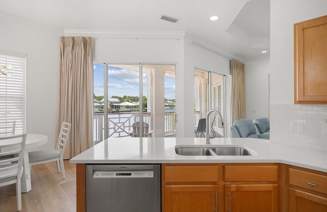 2221 Crystal Cove Ln Unit 2221, Miramar Beach, FL 32550 - kitchen with stainless steel dishwasher, crown molding, visible vents, light countertops, and a sink
