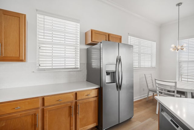 2221 Crystal Cove Ln Unit 2221, Miramar Beach, FL 32550 - kitchen with light countertops, decorative backsplash, stainless steel appliances, and light wood-style flooring