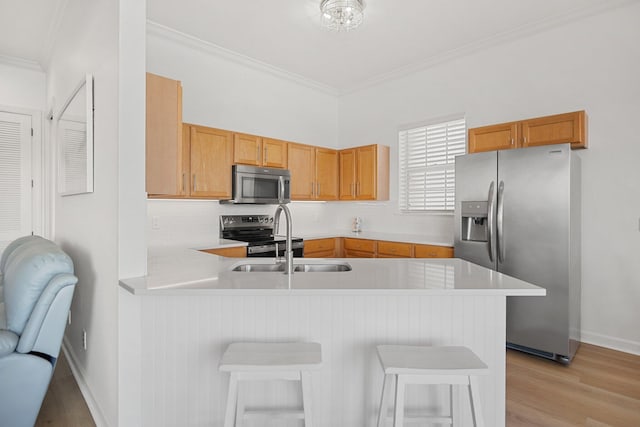 2221 Crystal Cove Ln Unit 2221, Miramar Beach, FL 32550 - kitchen featuring crown molding, light countertops, stainless steel appliances, and a peninsula