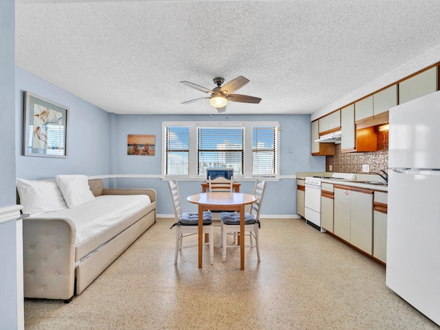 8730 Thomas Dr # 1203C, Panama City Beach, FL 32408 - interior space featuring baseboards, light speckled floor, ceiling fan, and a textured ceiling