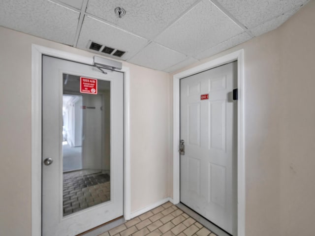 8730 Thomas Dr # 1203C, Panama City Beach, FL 32408 - entrance foyer featuring baseboards, visible vents, and a drop ceiling