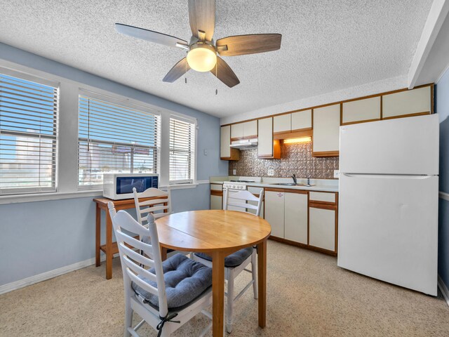8730 Thomas Dr # 1203C, Panama City Beach, FL 32408 - dining room with a textured ceiling, ceiling fan, and baseboards
