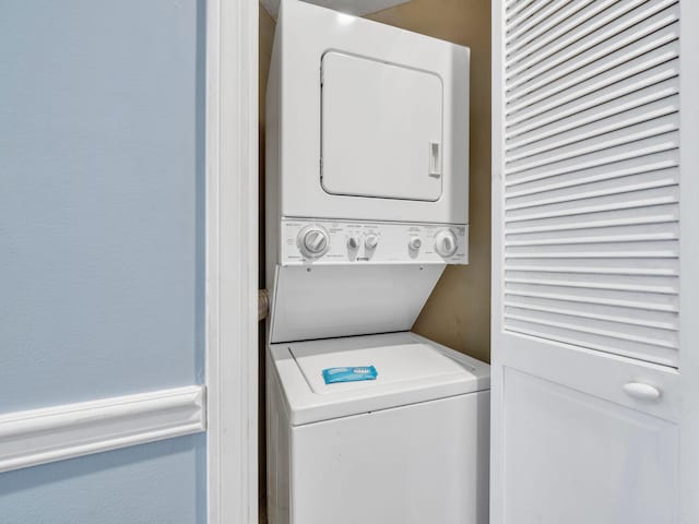8730 Thomas Dr # 1203C, Panama City Beach, FL 32408 - clothes washing area featuring stacked washer and dryer and laundry area