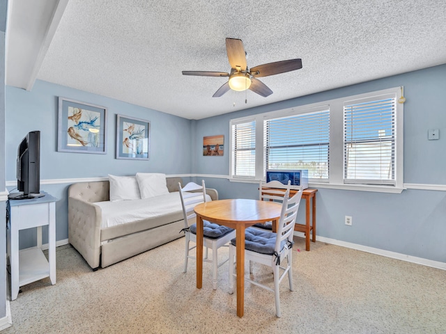 8730 Thomas Dr # 1203C, Panama City Beach, FL 32408 - dining room with a textured ceiling, ceiling fan, and baseboards