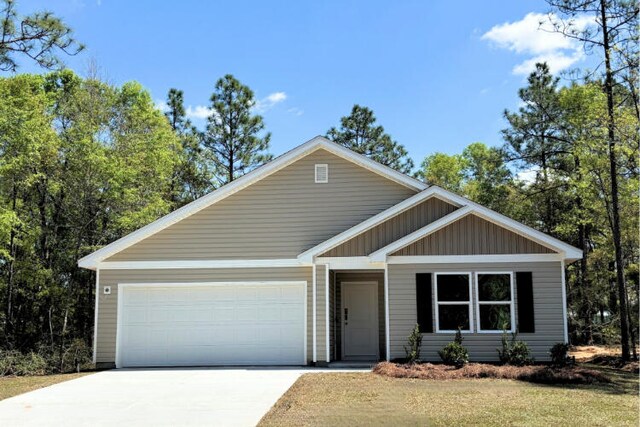 view of front of house with an attached garage, board and batten siding, and driveway