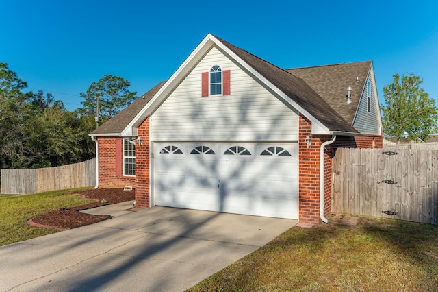 exterior space featuring fence, an attached garage, concrete driveway, brick siding, and a shingled roof