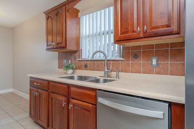 kitchen featuring dishwasher, light countertops, a sink, and light tile patterned floors