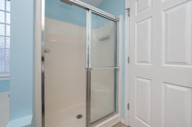 full bath with a shower stall