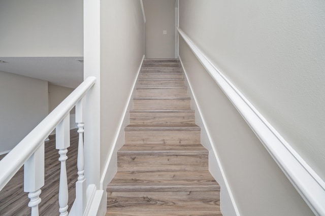 staircase with wood finished floors