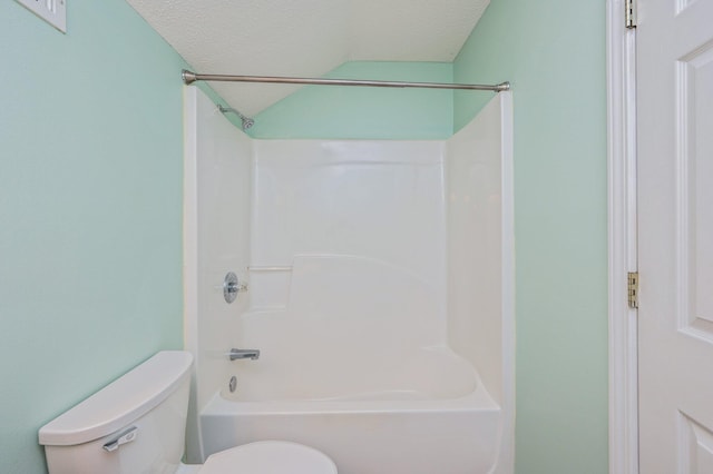 full bathroom featuring toilet, bathing tub / shower combination, and a textured ceiling