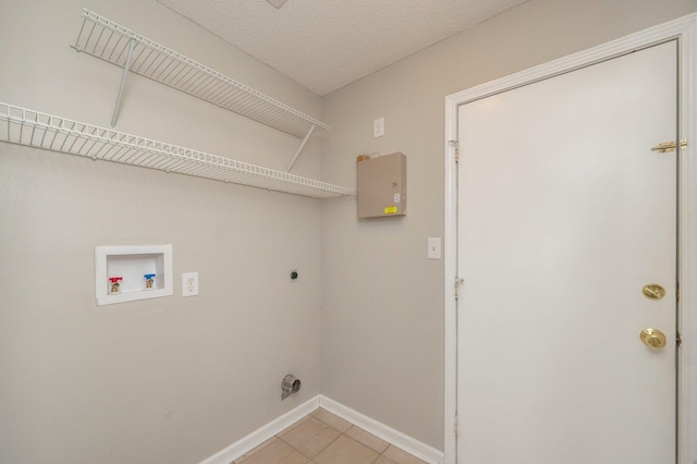 laundry room with washer hookup, a textured ceiling, electric dryer hookup, laundry area, and baseboards